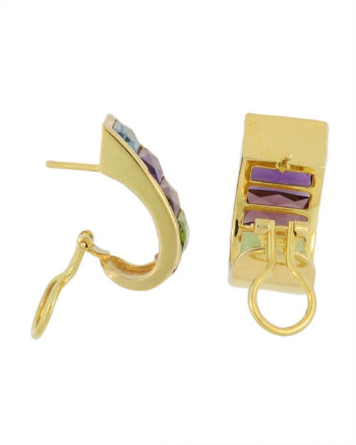 These earrings are clearly marked H. Stern and are set in 18KT yellow gold. They are part of the rainbow collection and feature semi-precious stones. Citrine, Peridot, Garnet, Amethyst, Blue Topaz. They are finished by an omega clip and post.