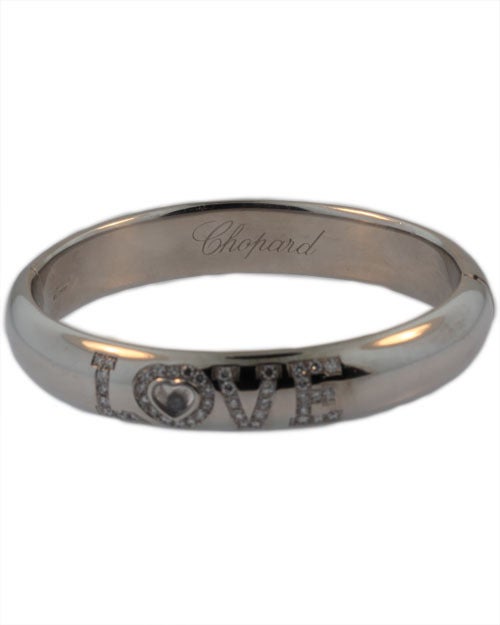 This Chopard bracelet is a classic. It is set in 18 KT white gold and signed Chopard with a registration number 9410448. It features 1 ct of high quality diamonds, with the happy diamond framed in the center of the 'O'.  The bracelet is in excellent