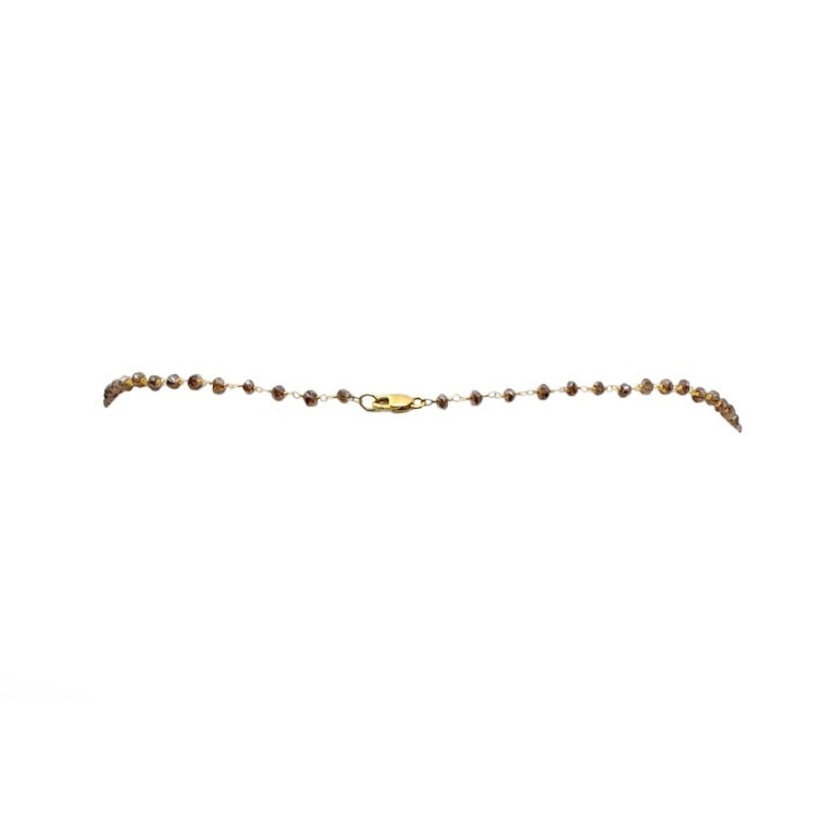 A necklace of briolette-cut champagne (brown) diamond beads set in 18kt white gold. The diamond beads measure from 3 mm to 4 mm with a gross weight of 23.91 carats. Length: 18