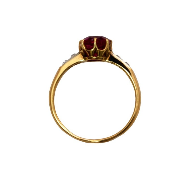 An Art Deco antique cushion-cut burmese purplish-red ruby (no-heat, no oil) ring with four old-european diamonds set in 14kt yellow gold. The 1.86 carat burmese ruby accompanies a gemological report from the American Gemological Lab stating the