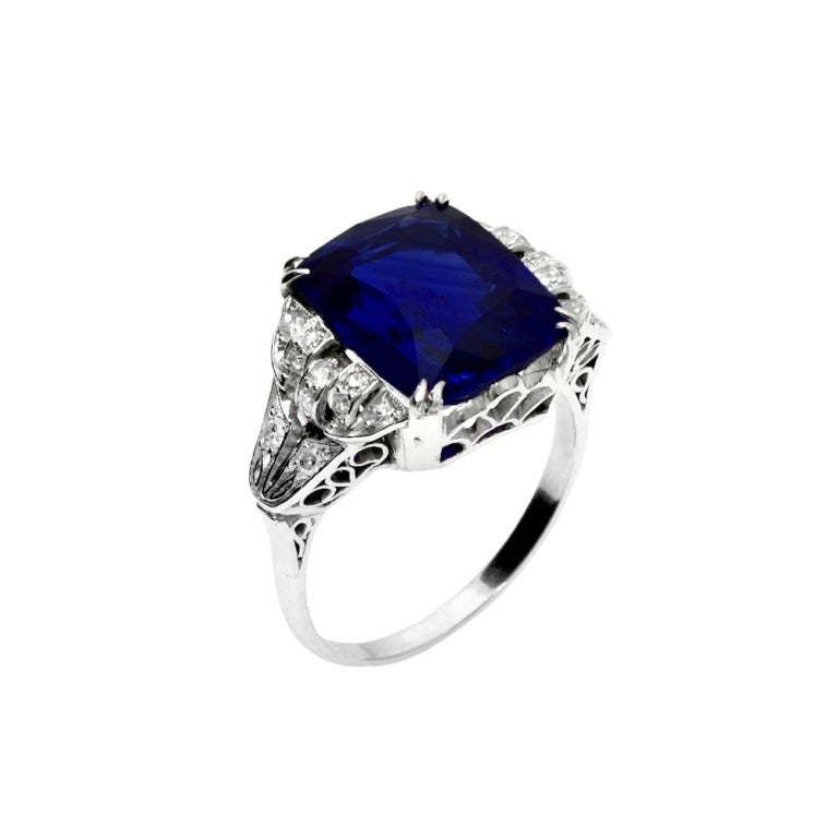 A stunning royal blue 10.15 carat cushion-cut blue sapphire edwardian filigree ring with single-cut diamonds, set in Platinum. The sapphire accompanies a gemological report from AGL stating the country of origin as Ceylon (Sri Lanka) with Heat