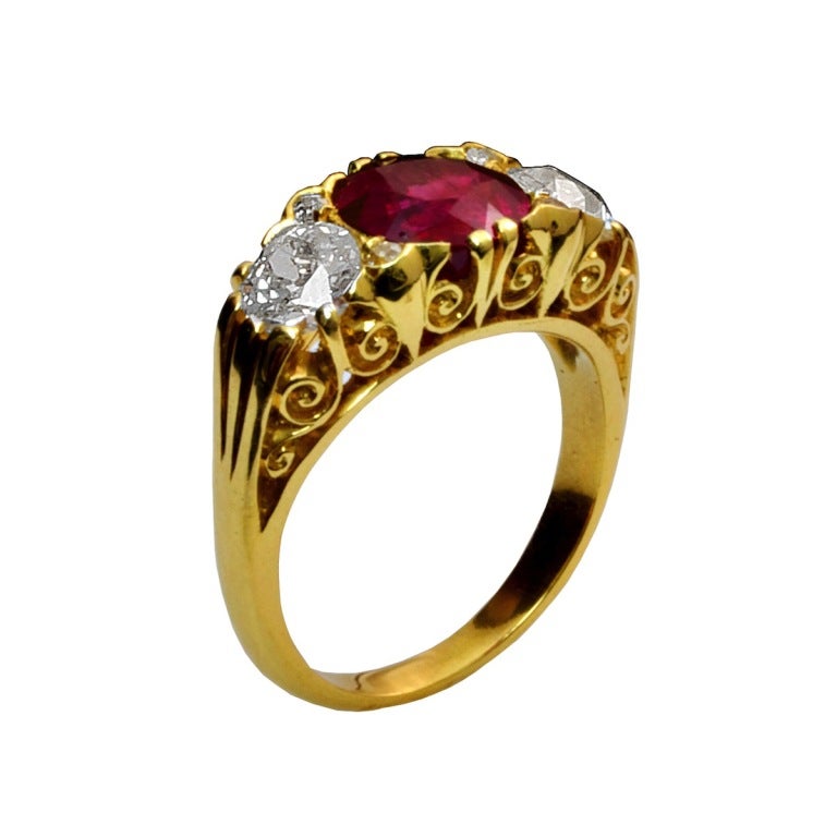 A 3.22 ct. cushion-cut burmese ruby (no heat) with two european cut diamonds, set in 18kt yellow gold Edwardian filigree ring. The ruby accompanies a gemological report from AGL and SSEF stating the country-of-origin as Burma (Myanmar) with No Heat