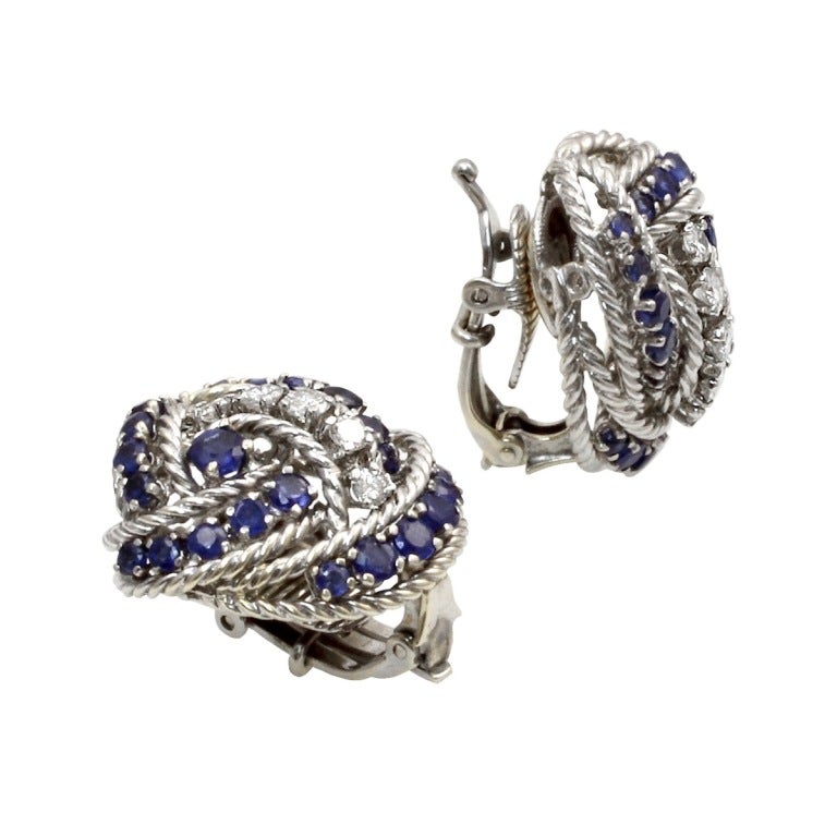 A beautiful and elegant pair of Tiffany & Co. Sapphire and Diamond Earrings. Each earring has twenty-three sapphires and 5 round brilliant-cut diamonds. Stamped 18K & 