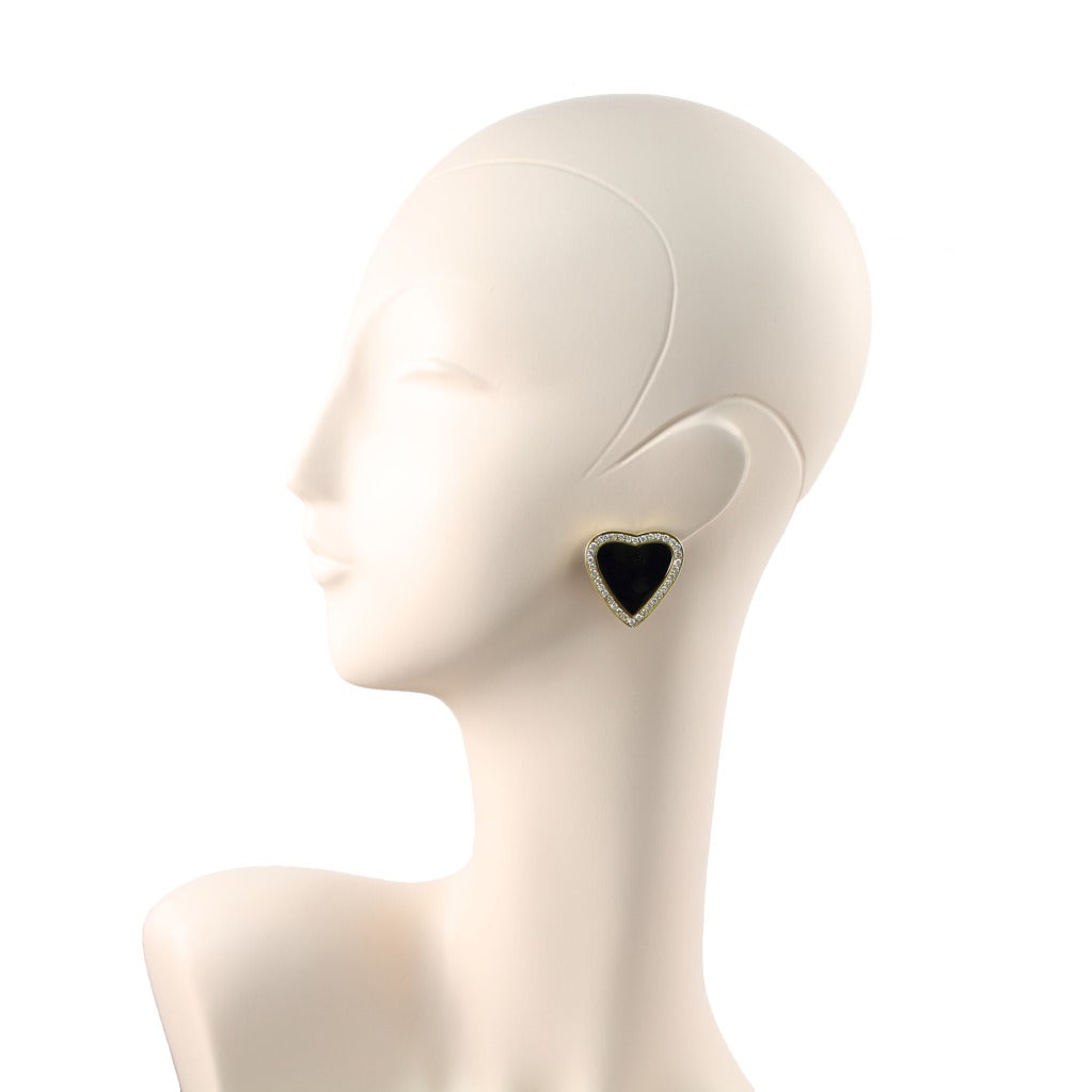 A pair of heart-shape black onyx and diamond earrings set in gold.