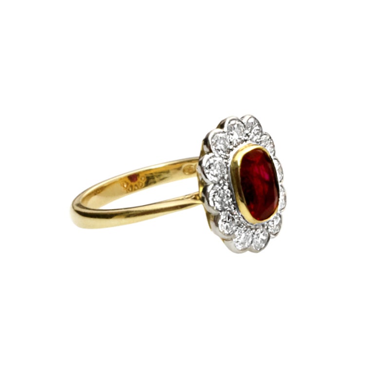 A stunning natural antique cushion-cut burmese ruby (no-heat, no oil) ring with brilliant-cut diamonds set in 18kt yellow gold. The 1.96 carat burmese ruby accompanies a gemological report from the American Gemological Lab stating the country of