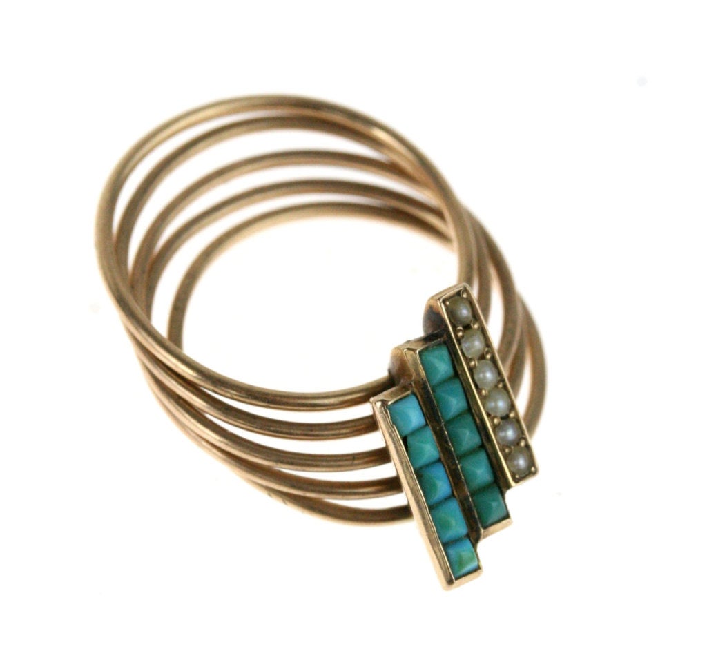 - 15k rose gold; square-cut Persian turquoise; genuine, uncultured seed pearls

This is a spectacular find--a stunning design of five gold rings, hinged together beneath a frontispiece that beautifully mixes Persian turquoise with genuine,