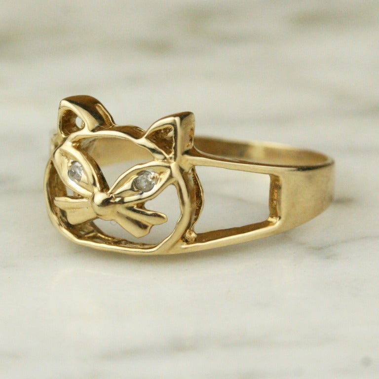 - Vintage Gold Cat Ring with Diamond Eyes
- c. 1960
- 10k yellow gold, diamonds

A whimsical little accent, this vintage 10k gold cat ring features delicate diamond eyes.

SIZING
Size 8 - can be sized

- Face length: 10 mm
- Diamonds: two