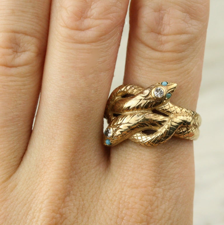 - 14k yellow gold, turquoise, diamond

A striking and wonderfully heavyweight vintage snake ring in lush 14k gold. The hand-engraved scales and dimensional faces gives this piece a delightful, old-world charm. The turquoise eyes and