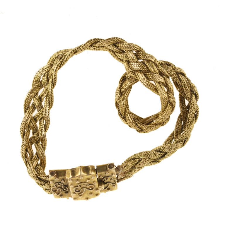 - Antique Woven Gold Bracelet with Clover Clasp
- c. 1885-1900
- 14k yellow gold

A breathtakingly beautiful example of the light, rich styles of late Victorian jewelry. This exquisitely worked 14 yellow gold woven gold bracelet features sweet