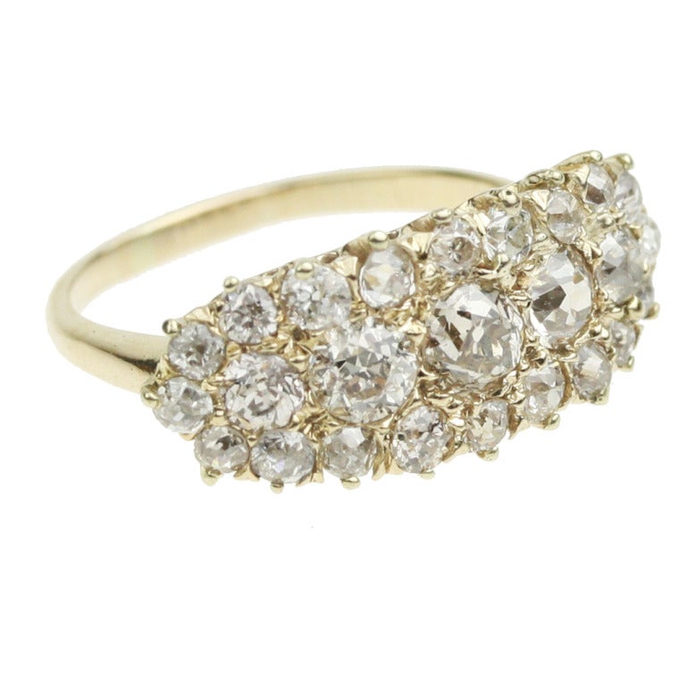 - Antique Diamond Cluster Engagement Ring
- c. 1880-1900
- 18k yellow gold, one .26 carat diamond, one .24 carat diamonds, one .21 carat diamond, one .09 carat diamond, one .12 carat diamond, twenty .05 carat diamonds, for a total diamond weight