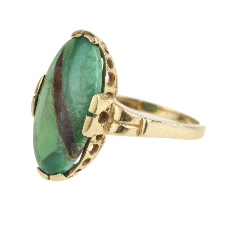 - Art Deco Turquoise Ring
- c. 1920-1935
- 10k yellow gold, veined green turquoise

An incredibly interesting piece, this eye-catching art deco navette ring makes artful use of the beautiful marbled coloring and diagonal veining in this un-dyed