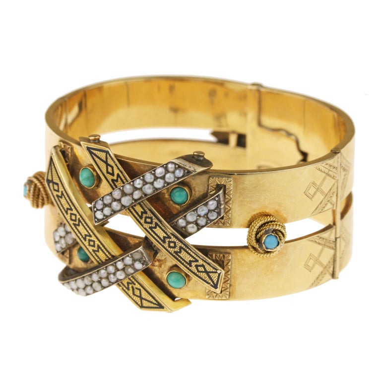 - Victorian Hinged Cuff Bracelet
- c. 1850-1870
- 14k yellow gold, 6 turquoise cabochons, 54 seed pearls

One of the most sensational pieces we have ever come across, this heavy-hitting Victorian cuff bracelet weighs in at a hefty 40.2 grams.