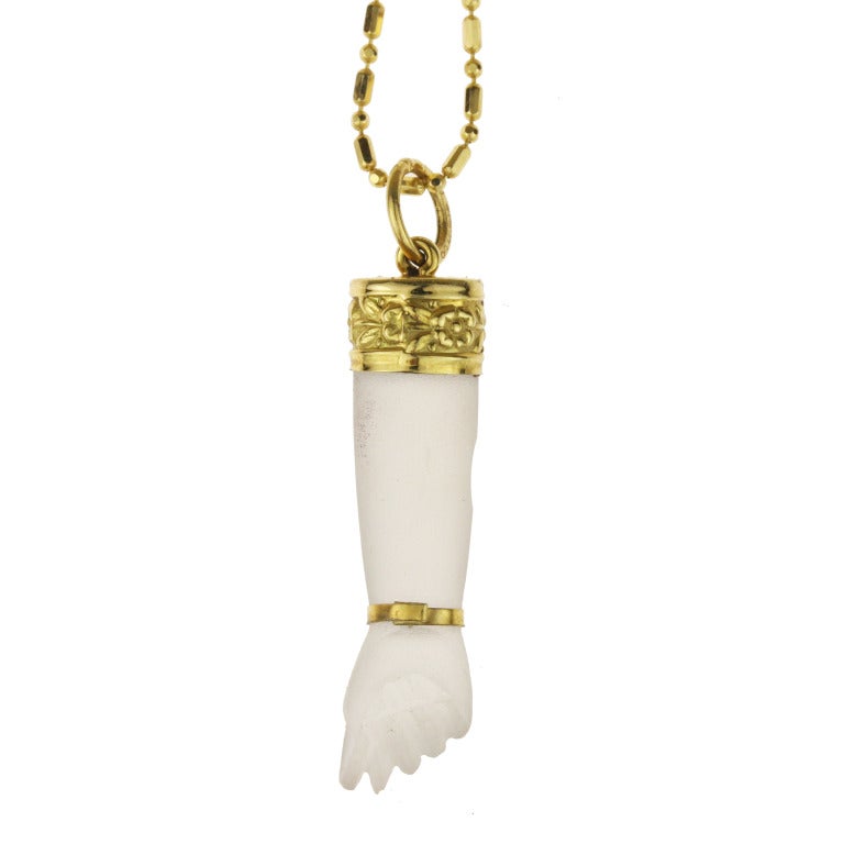 - Antique Rock Crystal Figa Amulet Charm in 18k Yellow Gold
- c. 1880
- 18k yellow gold, rock crystal

A stunning and very feminine take on the age-old figa charm, this frosted rock crystal hand features beautifully detailed floral-embossed 18k