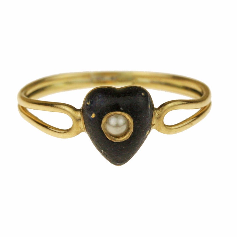 - Victorian Mourning Ring
- 19th century
- 18k yellow gold, seed pearl, enamel

Lovely and simple, this striking little ring features a black enameled heart inset with a delicate seed pearl. Fine looped details at the open shoulders finish off