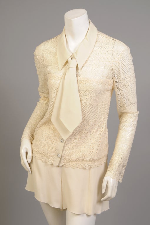 A lovely cream colored lace blouse is trimmed with silk georgette at the collar, detachable necktie and button placket. This is the same fabric used in the matching shorts. This would be a perfect outfit for Zoom meetings, wear it with the tie for