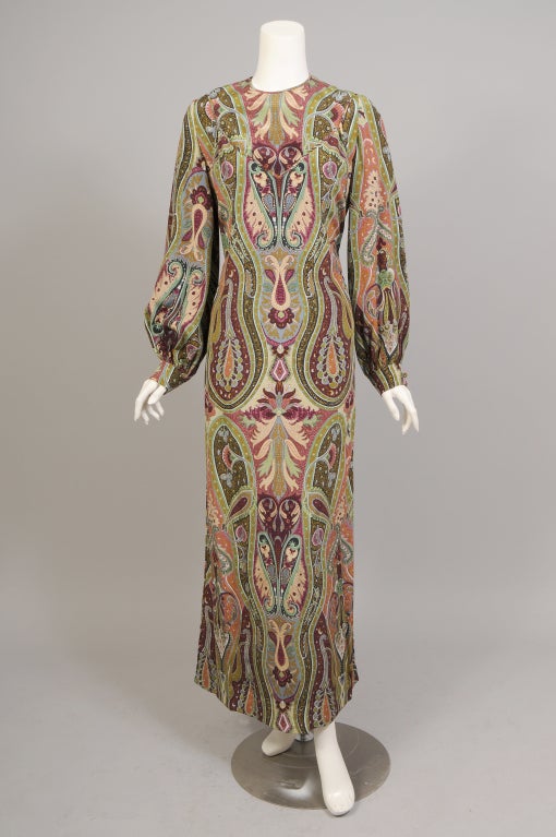 This is such an unusual design from James Galanos, retailed by Bergdorf Goodman in the 1970's. The basic dress is made from a striking multi color silk paisley. It has a round neck, long sleeves, a center back zipper, two pockets in the side seams,
