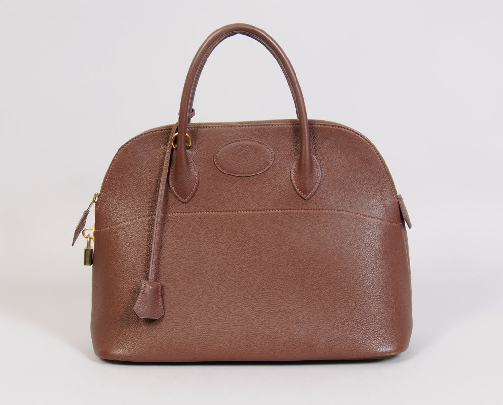 A stunning and pristine, large size, 37cm Hermes Bolide bag in rich brown leather comes complete with a shoulder strap, lock keys and clochette. The bag is fully lined in soft brown leather with one roomy pocket. The exterior is pristine and appears