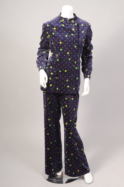 This late 1960's or early 1970's ensemble from Givenchy is so cheerful. Navy blue cotton velvet is printed with big chartreuse and green polka dots and smaller red polka dots. The jacket has a Nehru collar, buttons on the left side of the center,