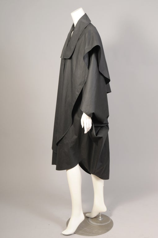 This is an absolutely fabulous charcoal grey cotton raincoat from Issey Miyake, my mannequin does not do it justice! A great example of form and function this voluminous coat serves as truly chic rain protection. A generous collar, two enormous
