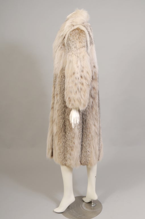 A Ben Kahn design, this striking Lynx coat is in pristine condition. The fur is soft and supple, freshly cleaned, and shows no signs of wear. It is fully lined with an interior tie closing, and a deep inside pocket. There are fur hooks for closure.