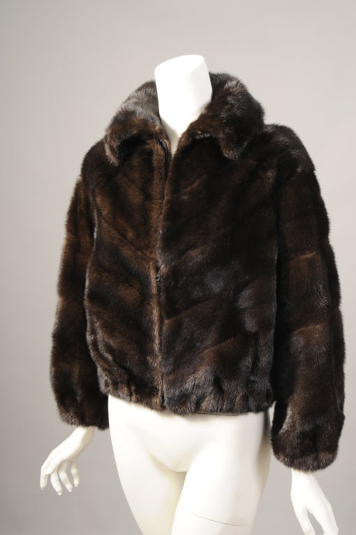 This ranch mink jacket will look just as good with an evening dress as it will with jeans, it is that versatile. The pelts are worked in a V shaped pattern on the front of the jacket with horizontal pelts on the sleeves and the back of the jacket.