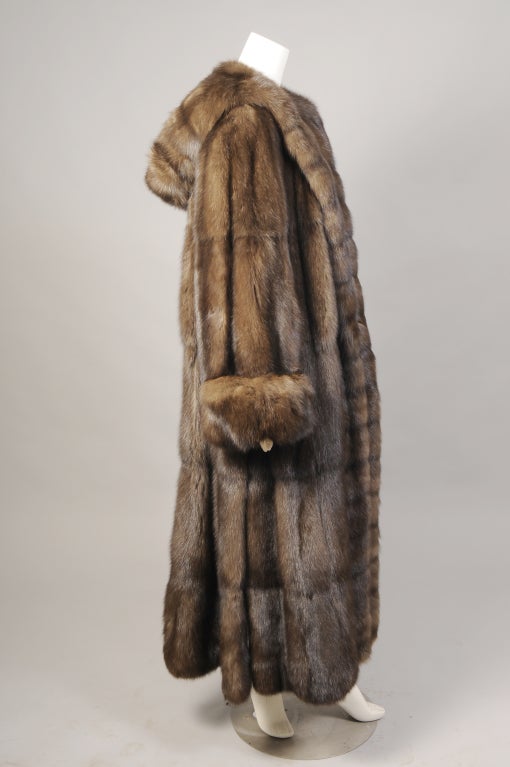 Italian designer Giuliana Teso has been designing furs for Neiman Marcus since 1988. This luxurious full length Russian Sable coat is an outstanding example of her work. The generously cut coat has a hood, shawl collar, deep cuffs and generous slits