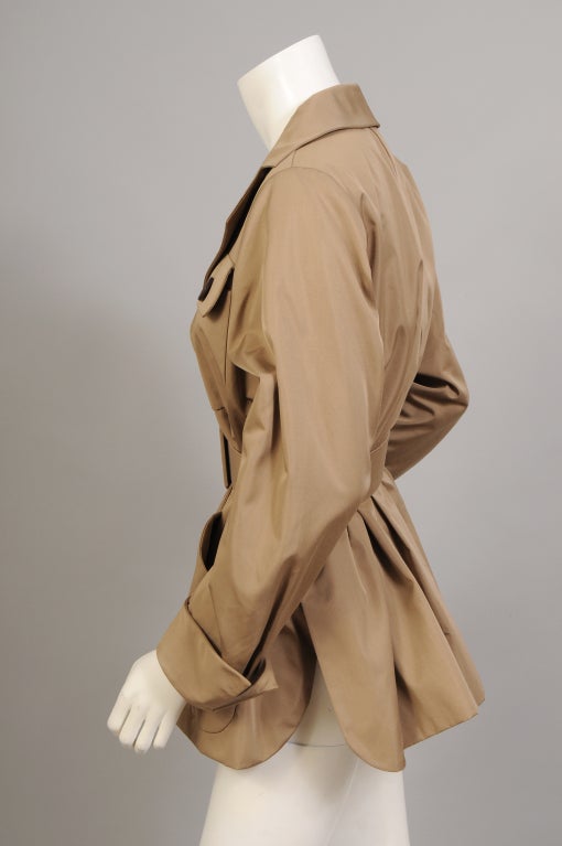 A rare and pristine numbered Haute Couture safari jacket from Yves Saint Laurent is done in a lightweight silk fabric. The jacket has a notched collar, one breast pocket and two hip pockets, three buttons at the center front and full cut sleeves