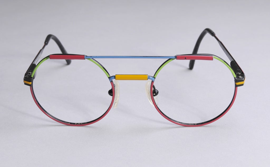 Bold primary colors and an appealing shape make these French eyeglasses a conversation starter. There is one tiny spot on the red bar above the left eye, otherwise they are in great condition.

Measurements;
Across the top bar 3 1/2