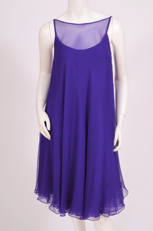 This 1960's cocktail dress from Nina Ricci is the most beautiful shade of deep, rich violet. The dress is made from three layers of silk chiffon over an orchid silk charmeuse lining. It is completely hand finished, and all of the seams are hand