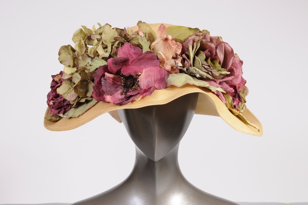 Inspired by Edwardian hats this finely woven straw hat is trimmed with cabbage roses and hydrangeas. A pale pink ribbon adds a bit of whimsy to the back of the hat. Designed for the Frank Olive Private Collection it is in excellent