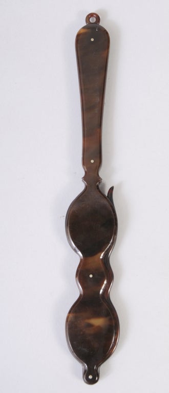 This rare and stylish lorgnette in tortoise shell can be suspended from a chain around your neck.  The lenses magnify, making them very unique 