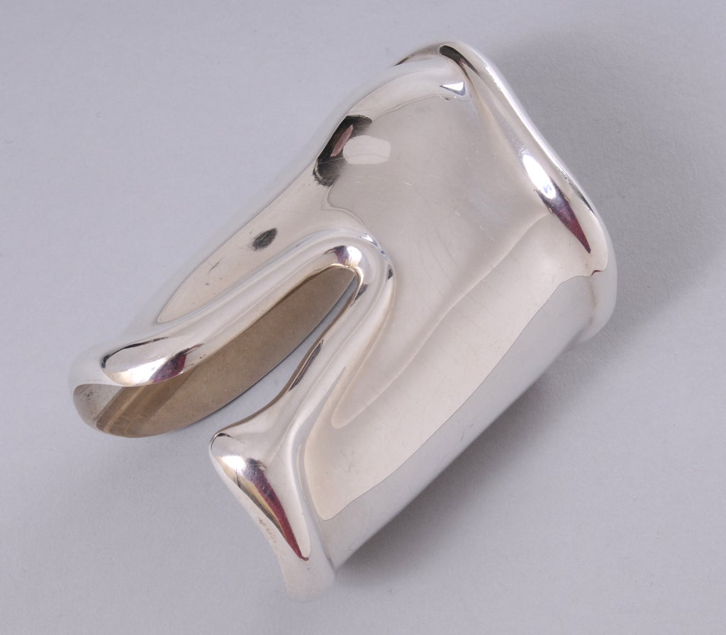 This rare small size sterling silver bone cuff was designed by Elsa Peretti for Halston in 1978 and retailed by Tiffany & Co. Made specifically for the left wrist the bump in the bracelet fits comfortably over your wrist bone. These bracelets were