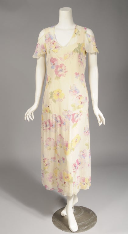 A vintage inspired floral print in pastel colors on a cream background makes this Sonia Rykiel dress look like something from the 1930's.  It is a far more sturdy 20th century version of this romantic look. The dress has acream silk slip