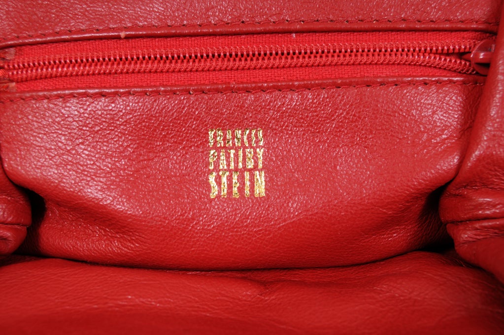 Francis Patiky Stein was a Fashion Editor at Glamour and then at Vogue magazine in the 1960's. She designed under her own name briefly before she was hired by Chanel Jewellry in Paris. 
This bright red quilted silk bag is trimmed with red leather.