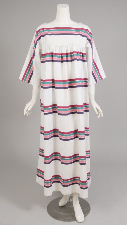 A Lidokke dress designed by Pentti Rinta in the early 1970's has a white background with bright and cheerful stripes. The dress is cut like a caftan and it has a matching tie belt. The vintage size is XS but please check the measurements, it seems a