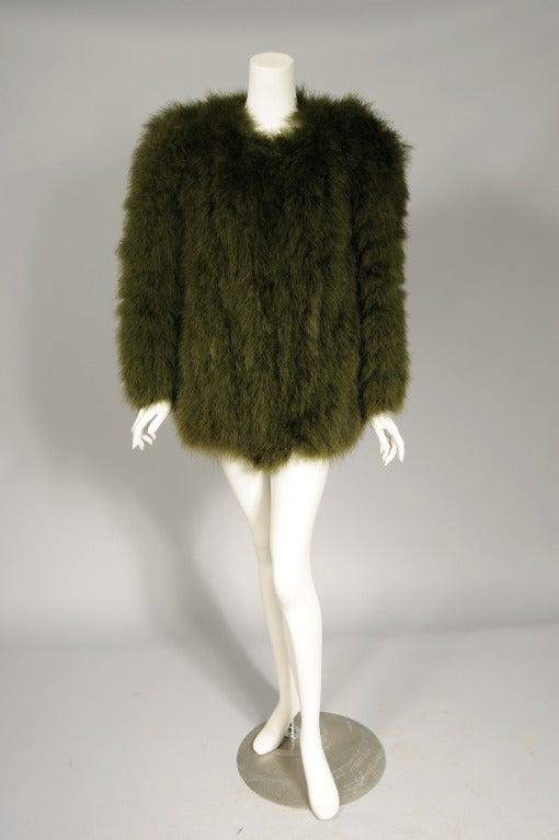 In the early 1970's Yves Saint Laurent presented a collection that was an homage to the war time clothing styles of the 1940's. This collection in turn created a demand for 1940's vintage clothing. This wonderful deep green marabou feather jacket