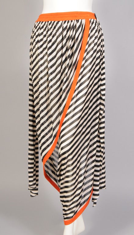 A graphic black and white stripe combined with bright orange trim makes these harem pants from Jean Paul Gaultier a real standout. There is an elastic waist, a draped panel front and back. ties on either side. and an I nternal brief to support the