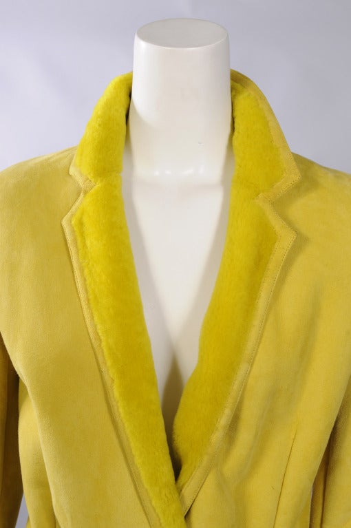 Unbelievably soft and supple this gorgeous yellow shearling jacket from Versace is a simple wrap style. The jacket has one interior button and a matching tie belt for closure. There are two pockets and a fabulous drawn work detail above each cuff.