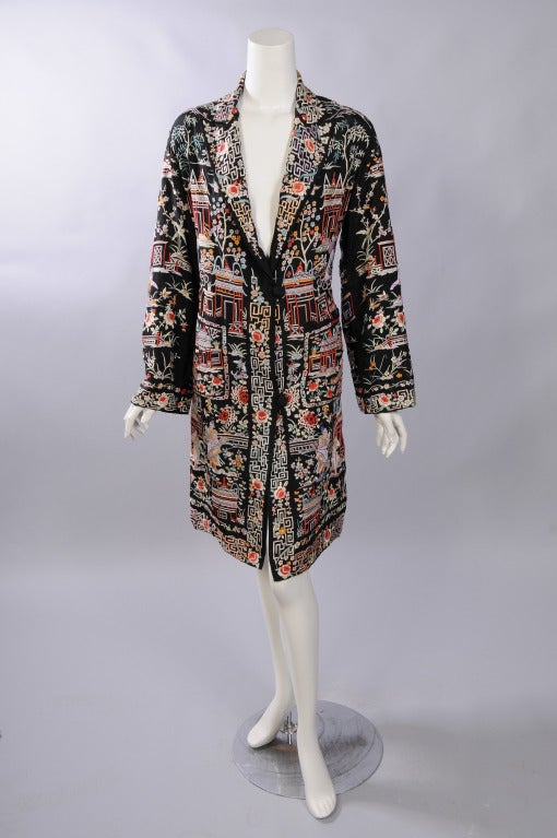 This stunning Chinese coat made for the Western market is beautifully embellished with people, animals, garden scenes and flowers. These Chinese men and women are seen in the garden, a pagoda and with their animals, all set against a black silk