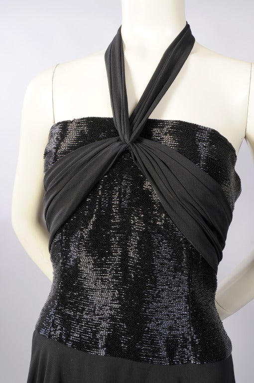 The bodice of this dress is beautifully beaded with row upon row of horizontal black bugle beads, A black chiffon panel is gathered at the center front emphasizing the bustline. The dress can be worn strapless, as a halter or with spaghetti straps.