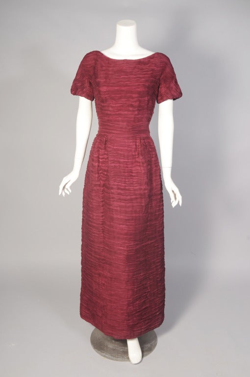 Sybil Connolly, the Irish Couturier,  is most famous for her extremely rare pleated linen clothing. Each garment used nine yards of linen to make one yard of pleated linen. This stunning cranberry linen evening gown was designed and made in the