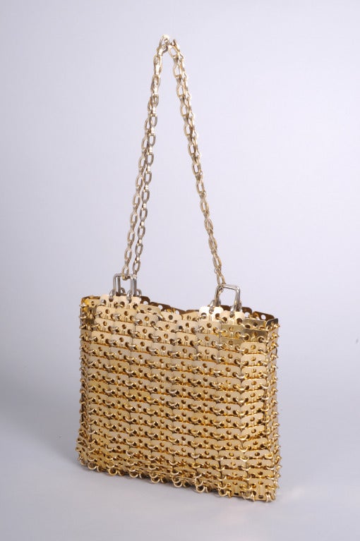 This unsigned Paco Rabanne gold toned metal bag has a long chain strap. It is in excellent condition and appears unworn. it is from the same estate as the Paco Rabanne dress kit.

Measurements;
Height 7 1/2