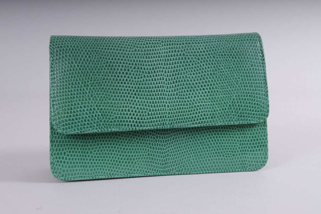 A gorgeous bright green lizard clutch or shoulder bag from Asprey, London will add a bright pop of color to your wardrobe. The ultra soft lizard skin bag has a zippered compartment on the back and two divided sections inside. The original mirror and