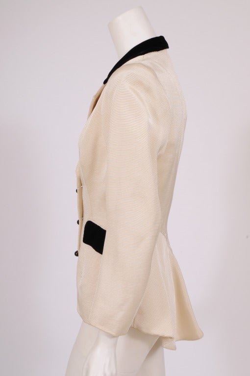 Leyna Beauvilian was a couture designer working at 1 Place Vendome, in the exclusive neighborhood of the famous Hotel Ritz in Paris, in the 1940's. 
This beautifully tailored cream colored silk ottoman jacket is accented with black velvet on the