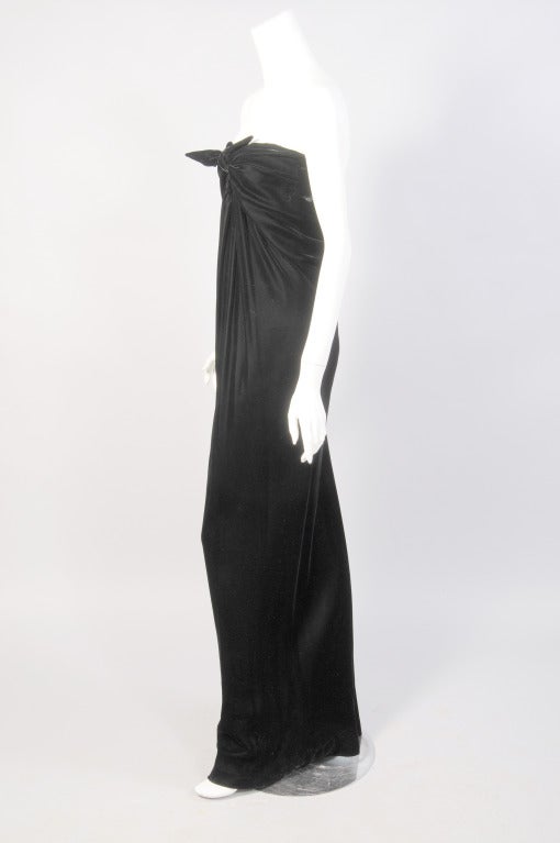 Halston designed this effortless black velvet column gown in 1976. Lee Radziwill was photographed wearing the dress that same year.  It slips on over your head and ties at the center front. The dress drapes beautifully around your body. It is fully