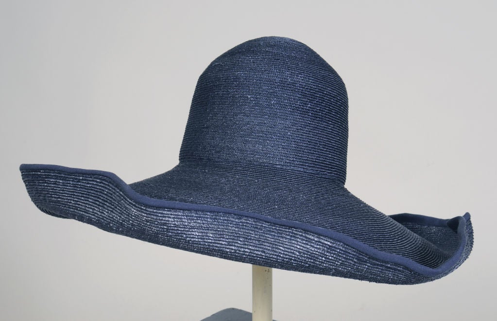 Deep navy straw with a wired wavy edge is the most attractive way to hide from the sun or the papparazzi!<br />
This fabulous hat, retailed in Milan, is in pristine condition and appears unworn.<br />
<br />
Measurements;<br />
Interior
