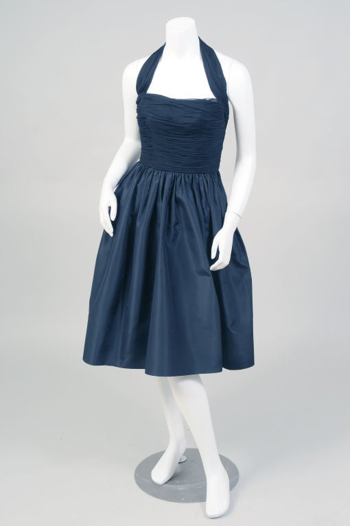 Wison Folmar designed for Jay-Thorpe and Maurice Rentner before moving to Edward Abbott in the 1950's.  This dress is a gorgeous example of his feminine evening dresses.<br />
The bodice and halter strap are ruched black silk chiffon over taffeta.