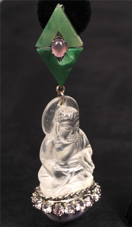 Fabulously dramatic, this handmade carved crystal pair of Buddha earrings from Iradj Moini are stunning. Moini was a jewelry designer for Oscar de la Renta before forming his own company in the 1980's.<br />
The Buddha figure is suspended from a