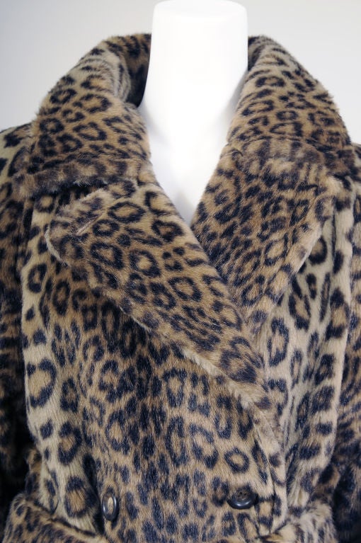 This is a great faux leopard coat from the Italian company Sportmax, a division of MaxMara.  It is styled like a classic trench coat, double breasted with a belt and two generous pockets.  The coat is fully lined with a gorgeous big logo at the