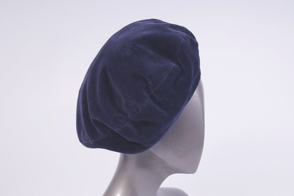 A chic Christian Dior navy velvet beret is from the estate of a former haute couture runway model and customer.<br />
It is fully lined in navy silk taffeta and it is in excellent condition.<br />
<br />
Measurements;<br />
<br />
Interior